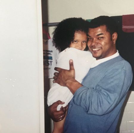 Sierra Capri, a baby in white with her dad.